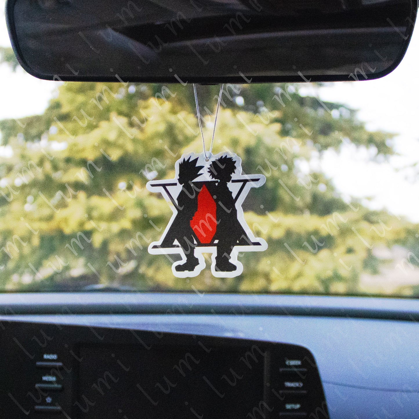 An image of a rectangular air freshener featuring Gon and Killua from the anime series Hunter x Hunter. The characters are depicted in a colorful and cartoonish style, with Gon on the left and Killua on the right. The air freshener appears to be hanging from a string